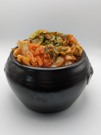 Kimchi served in a traditional onggi pot